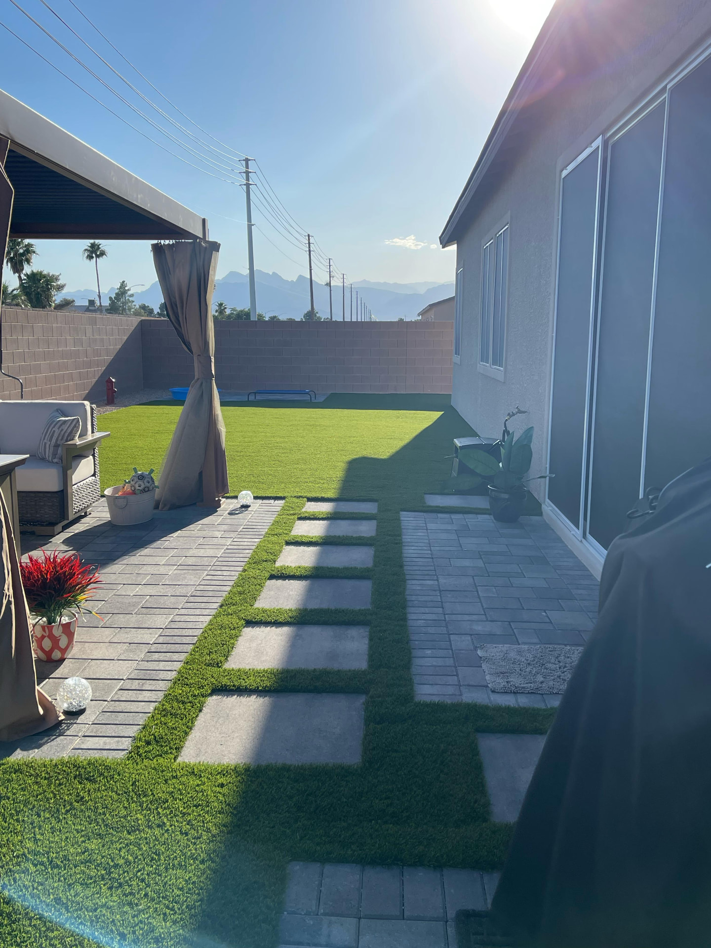Artificial turf with paver stepping stones in a Las Vegas side yard